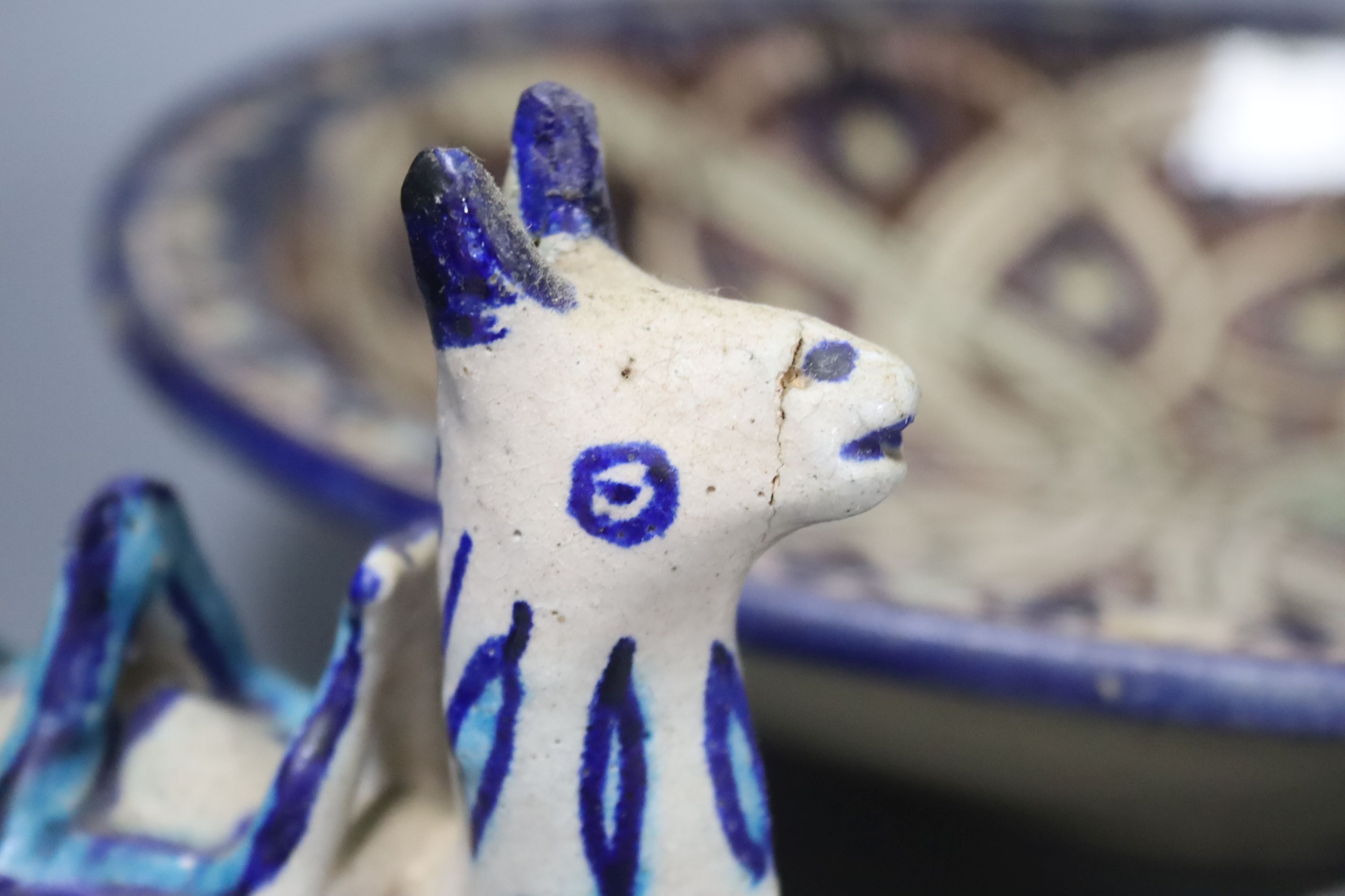 A Moroccan pottery dish, diameter 36cm, and three fritware animal figures